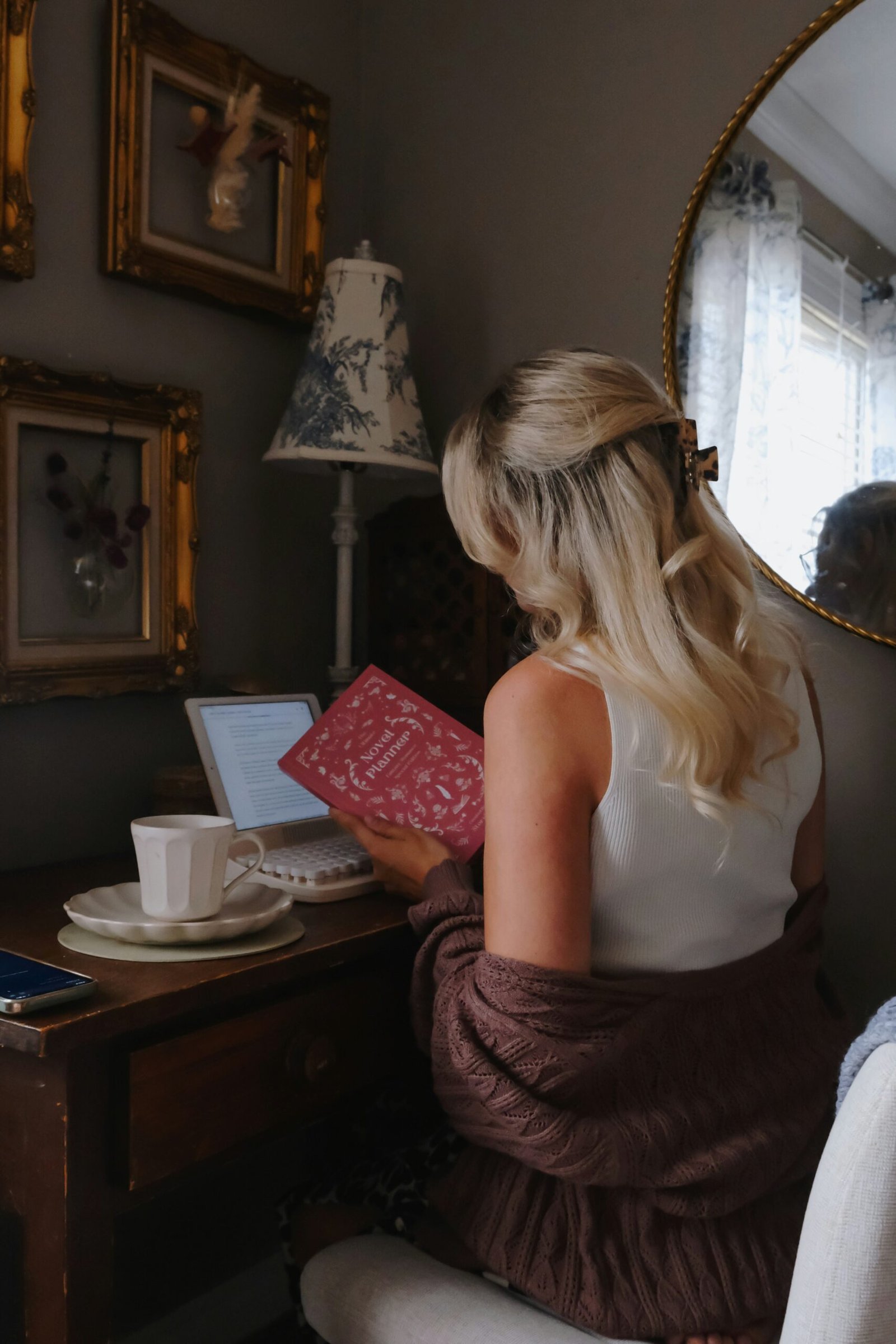 a woman sitting in a chair holding a book