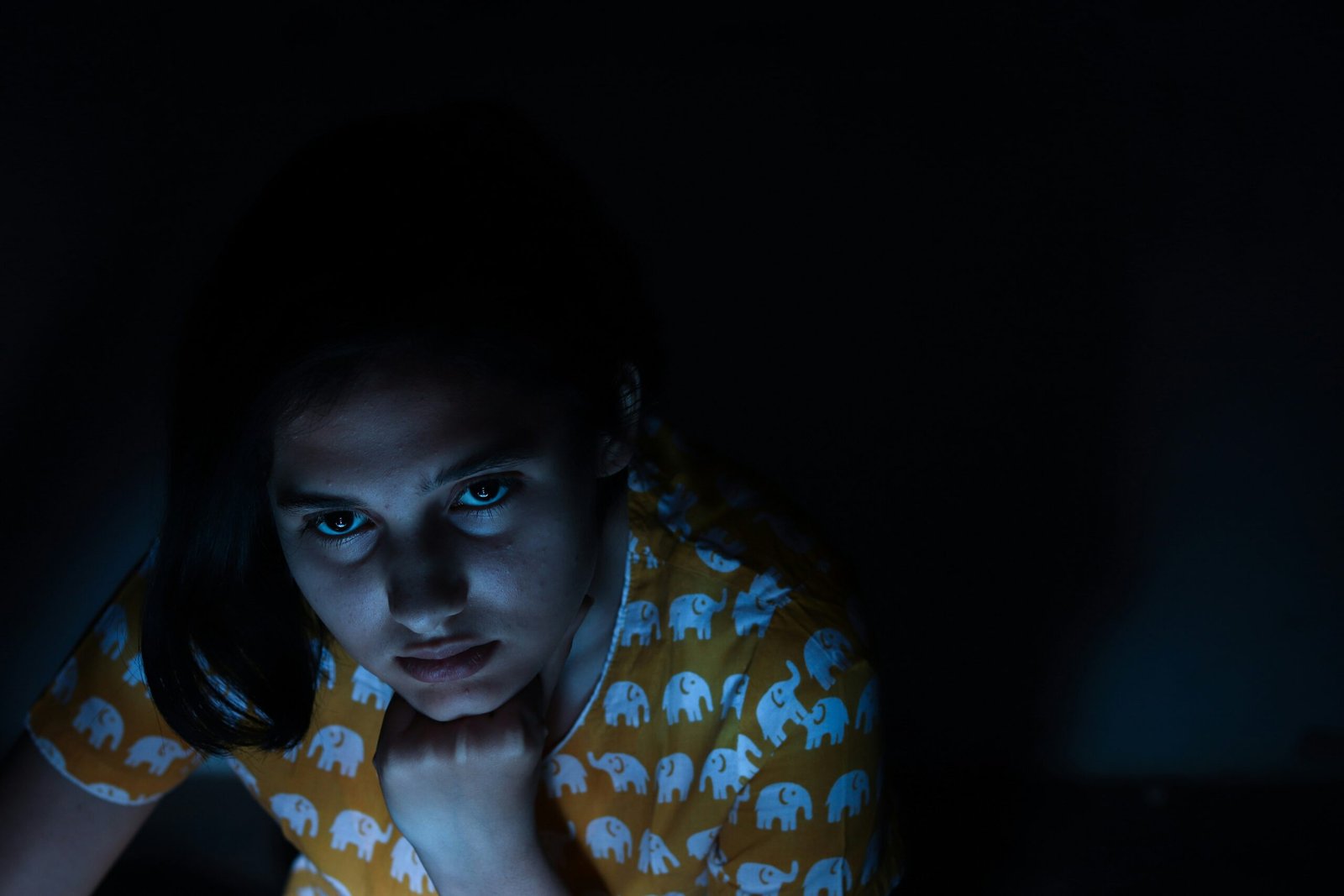 woman looking up inside dim-lit room